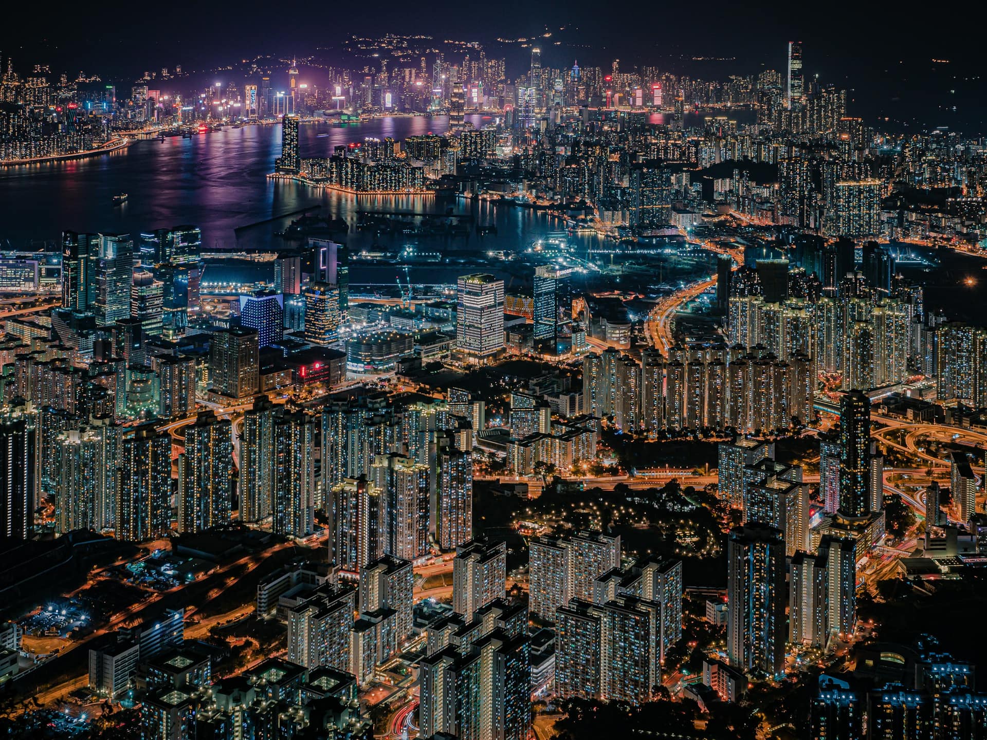 Hong Kong at night from Kowloon Peak, the city stretching to the harbour